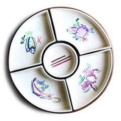A mid century vintage Poole Pottery seafood hors d'oeuvre set consisting of five ceramic dishes that fit snugly into a circular wooden tray. Each crescent shaped dish is decorated with a hand painted pattern of a shrimp, a flatfish, a crab and a scallop - designed by Truda Carter and hand painted on Poole Pottery's alpine white glaze. Each piece is stamped to its underside "Handmade Hand Decorated Poole England", along with the paintress's mark.