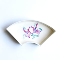 Part of a mid century vintage Poole Pottery seafood hors d'oeuvre set consisting of five ceramic dishes that fit snugly into a circular wooden tray. Each crescent shaped dish is decorated with a hand painted pattern of a shrimp, a flatfish, a crab (as shown here) and a scallop - designed by Truda Carter and hand painted on Poole Pottery's alpine white glaze. Each piece is stamped to its underside "Handmade Hand Decorated Poole England", along with the paintress's mark.