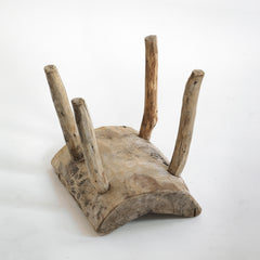 An antique primitive wooden stick stool, the top crafted from a single section of trunk.