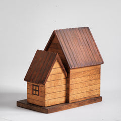 A vintage naive model wooden house piggy bank, the frontage with typography "National Savings Bank".