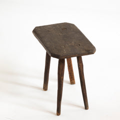 A vintage Romanian folk art small wooden side table with rustic stick legs.