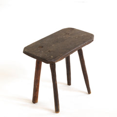 A vintage Romanian folk art small wooden side table with rustic stick legs.