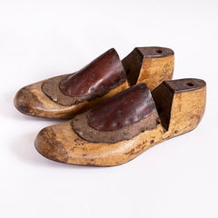 A good pair of antique late nineteenth century polished wooden shoe lasts with leather uppers and steel soles.