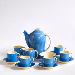 A complete 1930s Art Deco Susie Cooper Blue Crescent Kestrel coffee set decorated with small scarffito crescents, including coffee pot, milk jug, sugar bowl, and six coffee cans and saucers.