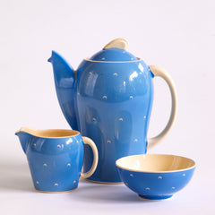 The coffee pot, milk and sugar in a complete 1930s Art Deco Susie Cooper Blue Crescent Kestrel coffee set decorated with small scarffito crescents. It includes a coffee pot, milk jug, sugar bowl, and six coffee cans and saucers.