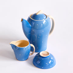 The coffee pot, milk and sugar in a complete 1930s Art Deco Susie Cooper Blue Crescent Kestrel coffee set decorated with small scarffito crescents. It includes a coffee pot, milk jug, sugar bowl, and six coffee cans and saucers.