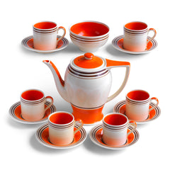 A stunning 1930s Art Deco Susie Cooper coffee set in her classic Rex shape with tango orange banding. The Susie Cooper trademark signature is on the underside of each piece, and the set includes a coffee pot, sugar bowl, and six cans & saucers - and all in wonderful condition.