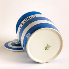 A good T G Green Cornish Kitchenware Prunes storage jar with lid dating to 1930. The "Prunes" typography is strong, and the jar is of a particularly large size. It bears the early 1930s Church Gresley stamp to its base and is marked "Green & Co Ltd / Gresley England".