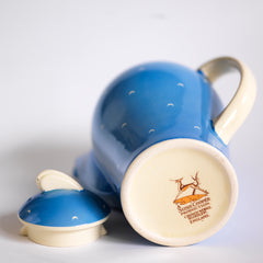 The leaping gazelle back stamp  in a complete 1930s Art Deco Susie Cooper Blue Crescent Kestrel coffee set decorated with small scarffito crescents. It includes a coffee pot, milk jug, sugar bowl, and six coffee cans and saucers.