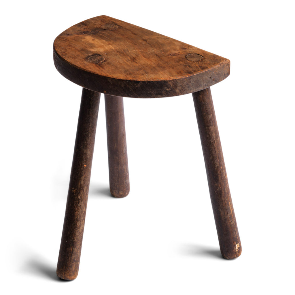 A rustic three-leg milking stool, ideal as a handy pull-up side table for bedside use or could be used by a chair for drinks. Year of manufacture: c.1920 Origin: UK Material: stained pine Dimensions: Width 27cm Height 32cm Condition: excellent