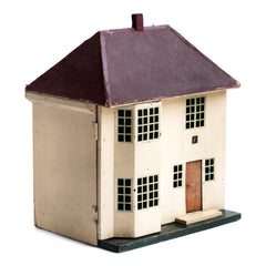 A charmingly suburban 1930s doll's house with a cream painted tin metal front, made by Triang.