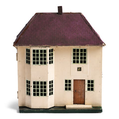 A charmingly suburban 1930s doll's house with a cream painted tin metal front, made by Triang.