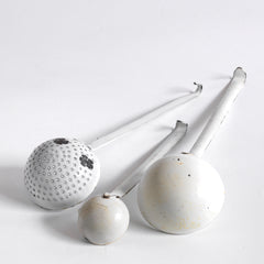 A collection of three vintage enamel kitchen ladles: a scoop with a perforated bowl - perfect for the singling out poached or fried food and draining; a large ladle, and a small sauce ladle with a handy pouring lip - and also ideal for gravy.