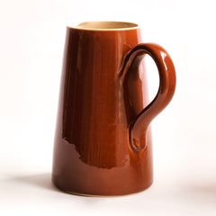 A large and rather handsome water jug in a rich toffee-brown glaze manufactured by Lovatts, and stamped "Lovatts" to its underside.