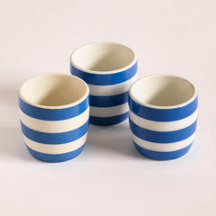 T G Green Cornish Kitchenware egg cups dating to 1930 - 1950. They bear the green shield stamp to their bases and are marked "T G Green and Co Ltd Cornish Kitchen Ware Made in England".
