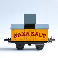A rare 1940s Hornby Trains 0-gauge series Saxa Salt wagon "Salt Wagon Saxa No.50", and in mint condition. It has an opening roof hatch, and comes with its original mint green box.&nbsp;