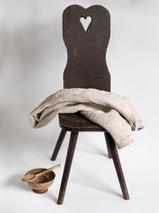 A vintage Romanian alpine folk art style stick-leg chair with high back and charming heart detail, most likely from the Carpathian Mountains.