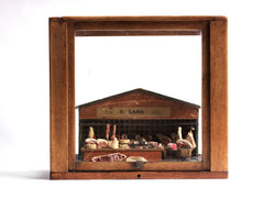 Antique butcher’s shop diorama with its original signage “U. Lamb” and “Family Butcher”. It is complete with counter, papered tiling, butcher’s blocks, butcher’s scales, and various composition cuts, sides and joints of meat – including strings of sausages and a pig’s head.
