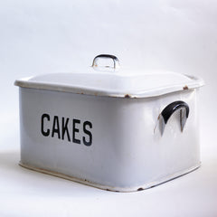 A rare 1930s rectangular half-size white enamel cake tin with rounded corners, original lid and good "CAKES" typeface in black.
