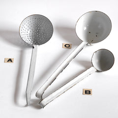 A collection of three vintage enamel kitchen ladles: a scoop with a perforated bowl - perfect for the singling out poached or fried food and draining; a large ladle, and a small sauce ladle with a handy pouring lip - and also ideal for gravy.