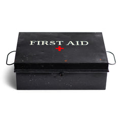 A good-looking first aid tin, the lid stencilled "First Aid" and with a red cross. It has a pair of carrying handles and its original black enamel paint finish.