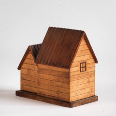 A vintage naive model wooden house piggy bank, the frontage with typography "National Savings Bank".