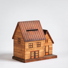 A vintage naive model wooden house piggy bank, the frontage with typography "National Savings Bank".