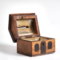 A vintage naive model wooden house savings box that resembles a Scottish bothy, with metal trim to its roof, along with metal windows and front door, here shown with hinged roof open.