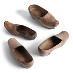 A collection of tiny French wooden children's sabot (clogs), some with hob-nails attached underneath. 