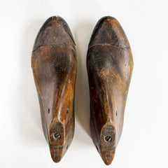A pair of mid nineteenth century polished wooden shoe lasts with leather toe-capped sides and excellent historical patina.