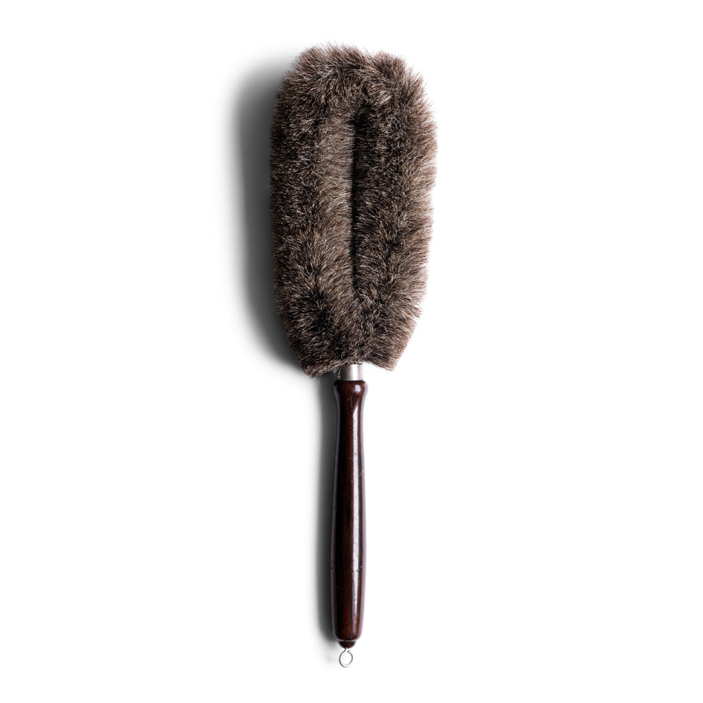 A handy 1930s household brush with an oval bristle arrangement, and excellent for dealing with all those awkward nooks and crannies around the home. It has a polished painted wood handle, and handy hanging loop.