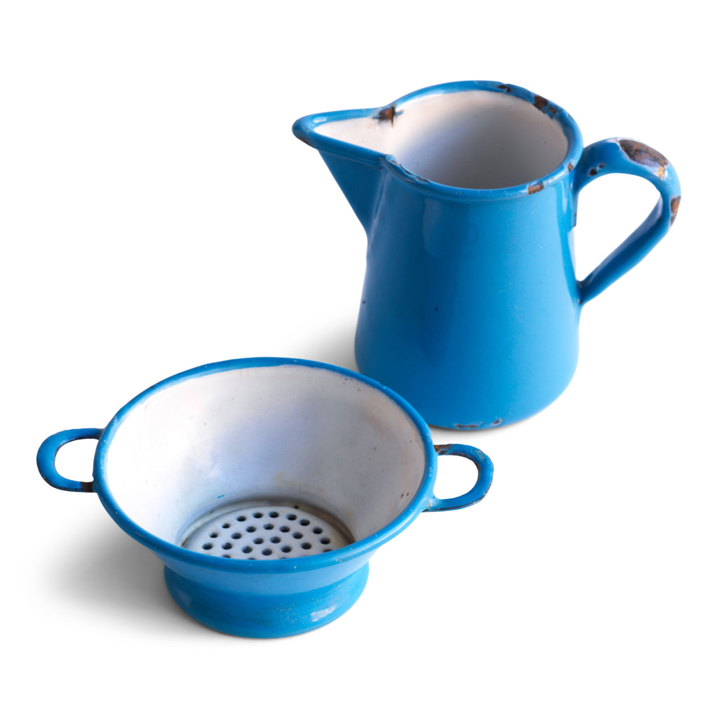 Two very pleasing antique miniature blue enamel kitchen items: a twin-handled sieve and a ewer shaped jug, each with a blue enamel exterior and a white enamel interior. These are part of an extensive collection of miniature pale blue enamel kitchen ware, previously owned by the miniaturist specialist and collector extraordinaire Joan Dunk.