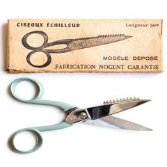 A fine pair of vintage French kitchen scissors designed to deal with the preparation of whole fish, one edge fashioned for de-scaling, and in their original box. As the box graphics advertise "Ciseaux Ecailleur", they do the job of fish scaling.