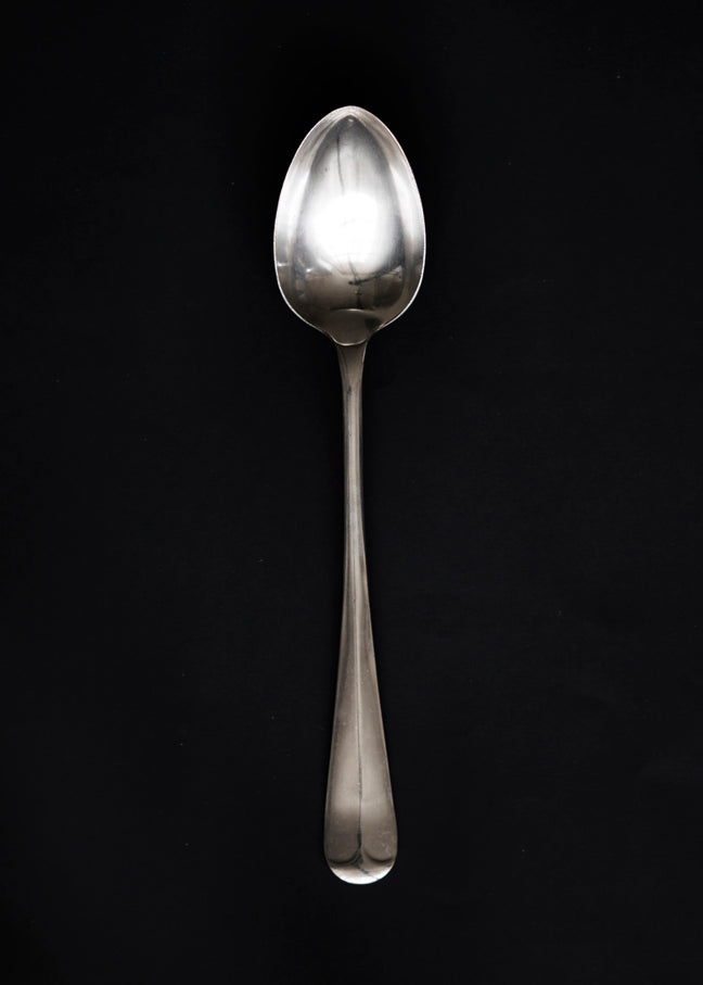 A large Georgian style silver-plated serving spoon with rat tail handle