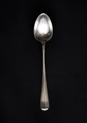 A large Georgian style silver-plated serving spoon with rat tail handle