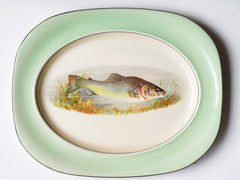 A glorious 1930s fish dinner service, complete with a large platter for serving a whole fish.  Each piece is embellished with a fresh water fish, such as pike, perch and trout, and contained within a mint-green border. Each item is stamped "Woods Ivory Ware England" to its underside.