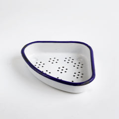 A handy sink tidy in white enamel with a blue rim; its triangular shape so designed so that it can easily be accommodated in the corner of your sink or drainer.  Set him by your sink to hold all your scourers, scrubbers and bits and bobs.  Also very handy for the collection of waste and scraps as you wash up. Your sink's best friend.