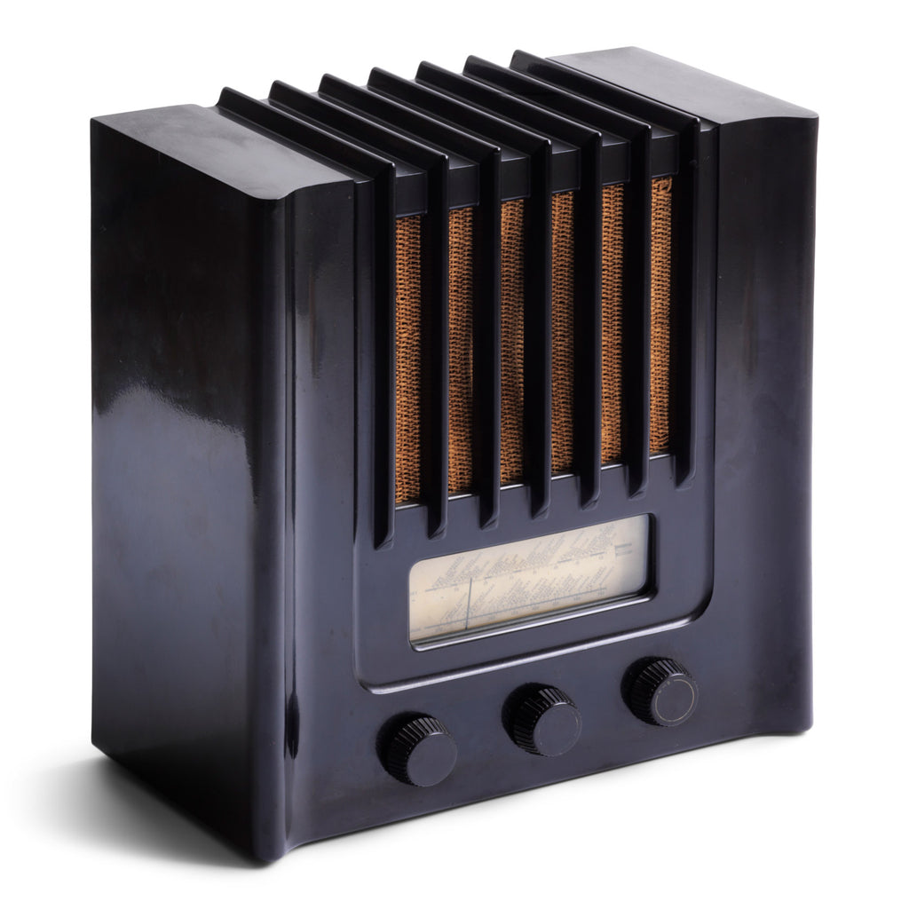 The British Murphy 4 valve AD 94  radio with distinctive Art Deco black Bakelite cabinet was manufactured from 1940.  Looking like a modernist building, this pioneering architectural style  radio resembles a powerhouse of electronic communications. Its streamline, futuristic mirrors  the Machine Age of the late 1930s.. Designed by Eden Minns in 1940.