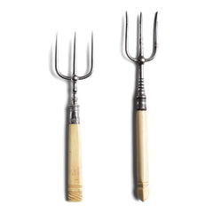 Two antique bone handle bread forks with Stirling silver mounts and silver plated tines. Each has a carved bone handle, and the larger has a finely carved tri-sided finial end.