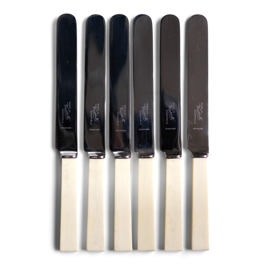 A good set of 6 square-ended dinner knives, each blade marked "Made in 'Westhill' Sheffield" with ivorine handles fashioned from xylonite and high-polished stainless steel blades.