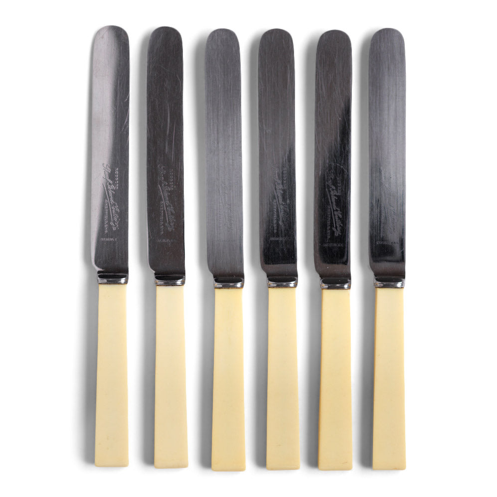 A set 6 1930s square end butter knives, each blade marked "Rodgers Sheaf Island Cutlery".