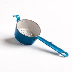 A miniature white speckled blue enamel saucepan with blue lid; a large frying pan; and a long-handled sieve. Part of an extensive antique and vintage collection of miniature pale blue enamel kitchen ware, previously owned by the miniaturist specialist and collector extraordinaire Joan Dunk.