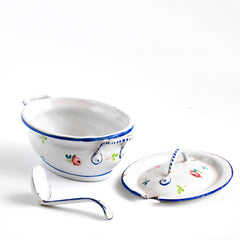 A wonderful, rare antique doll's enamel dinner service decorated with rose buds and leaf sprigs, and each piece finished with a blue trim; very much in tune with the current trend "cottage core", an aesthetic which celebrates an idealised rural life. This is part of an extensive collection of miniature enamel kitchen ware, previously owned by the late miniaturist specialist and collector extraordinaire Joan Dunk.