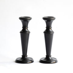 A striking pair of Edwardian ebony candlesticks. 
