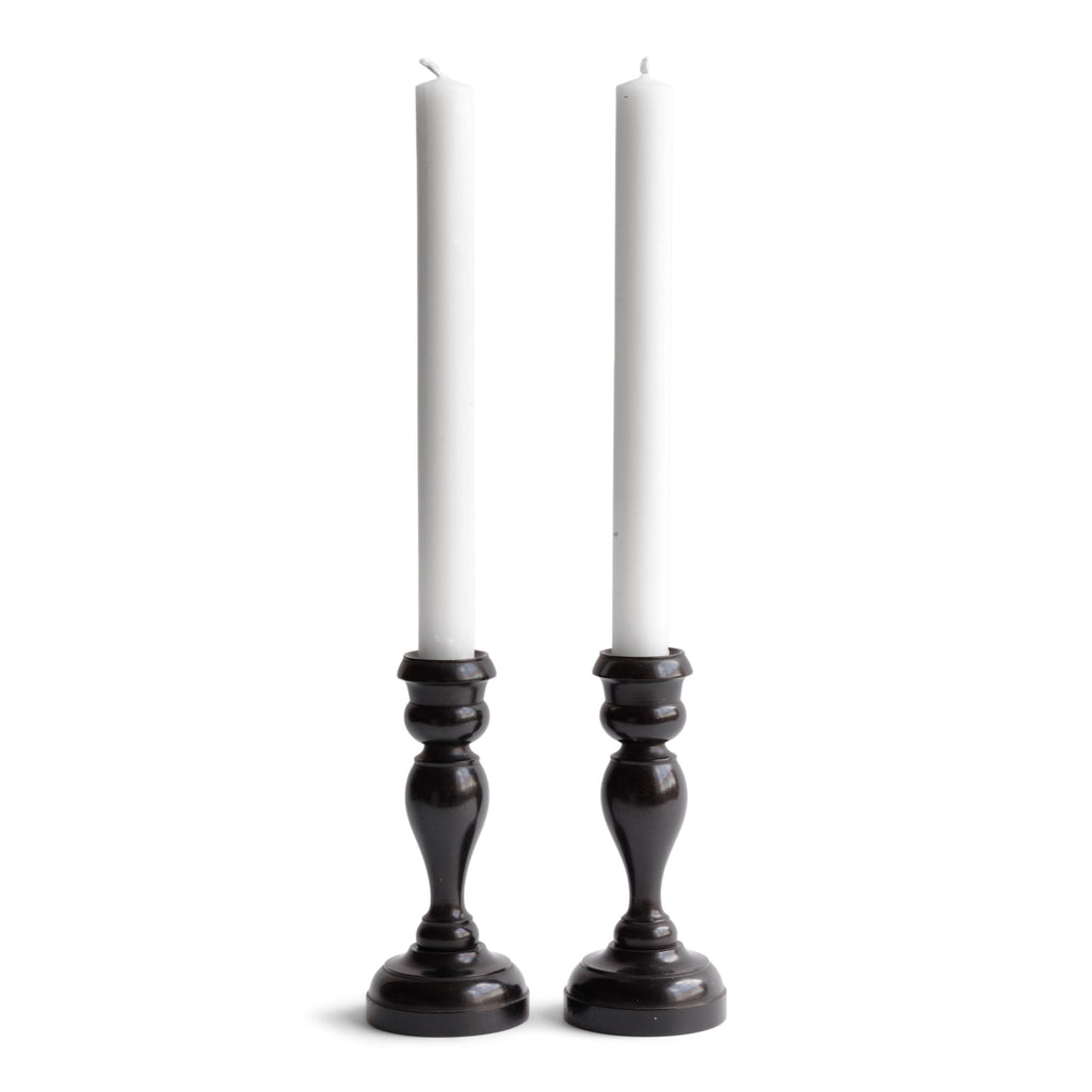A striking pair of Edwardian ebony candlesticks. 
