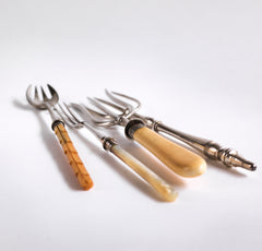 A collection of antique pickle, chutney and bread forks and spoons, all with Stirling silver mounts and silver plated tines.