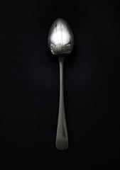 A large Georgian style silver-plated serving spoon with rat tail handle