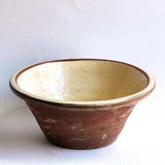 A very good-looking late nineteenth century bread proving bowl with a cream coloured glazed interior and a deep rolled rim.  The delightful glaze smudges on its terracotta exterior add character - and hand-thrown charm. Perfect for the kitchen or the dining table. We think wonderful when filled with vegetables or lettuces.