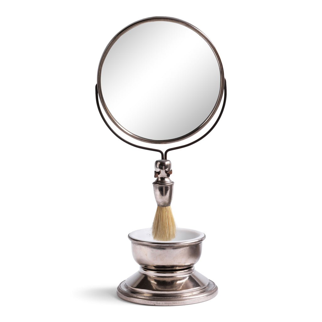 A good-looking Edwardian gentleman's shaving companion, consisting of a pivoting circular mirror set on a stand, a badger hair shaving brush and a white vitrolite glass bowl set in a nickel plated bowl-shaped stand. It was most likely made for travel, as it is light-weight and small, and therefore very transportable. 