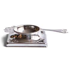 An Edwardian long-handled silver plated tea strainer with stand.  We have had this item re-silver plated, so it is in excellent condition.  Diameter strainer 6cm  Diameter of holder 9cm square  Length (handle to handle) 14.5cm